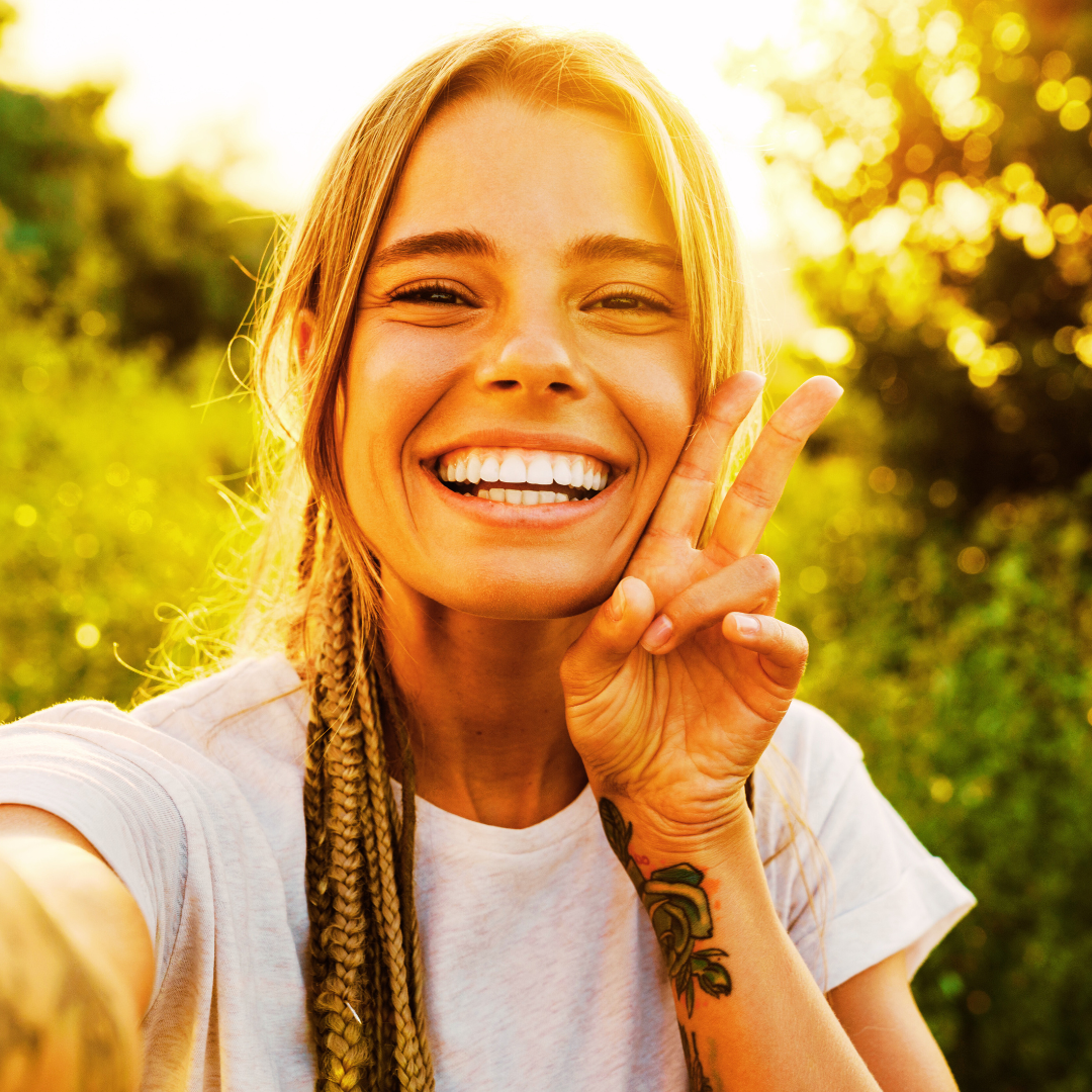 Person with clear, glowing skin smiling confidently after acne treatment.